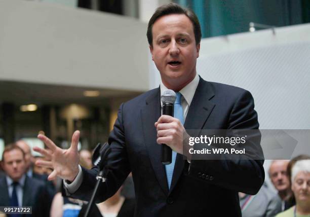 Prime Minister David Cameron talks to civil servants during a visit to the Home Office on May 13, 2010 in central London. Britain's new Conservative...