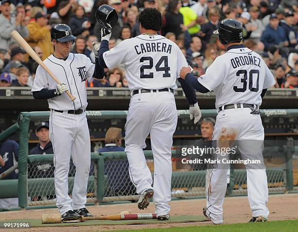Scott Sizemore of the Detroit Tigers congratulates teammates Miguel Cabrera and Magglio Ordonez during the game against the New York Yankees at...