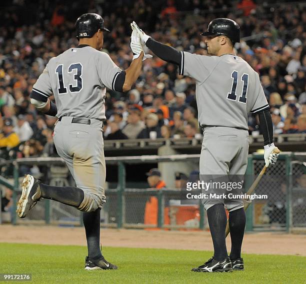 Alex Rodriguez and Brett Gardner of the New York Yankees high-five each other during the game against the Detroit Tigers at Comerica Park on May 10,...