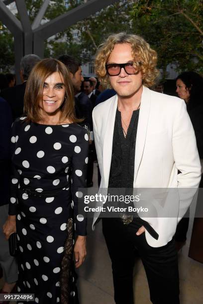 Carine Roitfeld and Peter Dundas attend amfAR Paris Dinner 2018 at The Peninsula Hotel on July 4, 2018 in Paris, France.