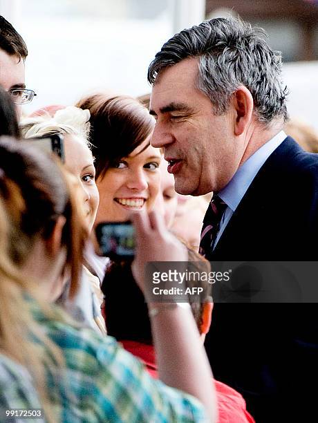Former British Prime Minister Gordon Brown greets staff and students before making a speech at Adam Smith College, in Kircaldy, Scotland, on May 13,...