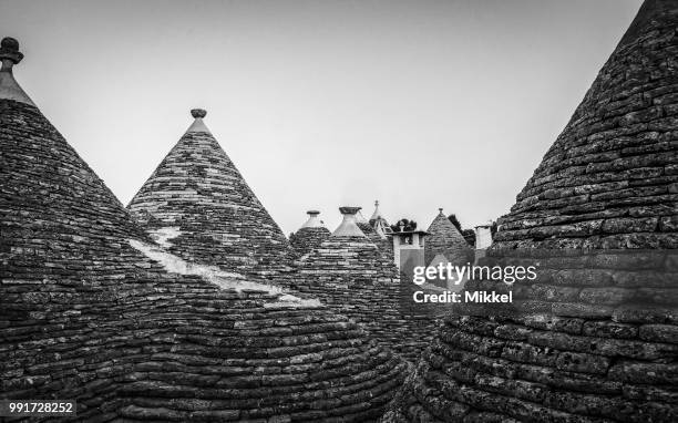 over the rooftops in alberobello - trulli photos et images de collection