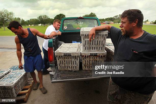 Crab fishermen Nathaniel Brunet, Mathew Cheramie and Michael Bailleaux wait for a wholesaler to sell their crab catch too, as efforts continue to...