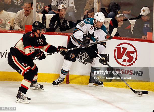 Patrick Marleau of the San Jose Sharks controls the puck under pressure from Jonathan Toews of the Chicago Blackhawks at the United Center on...