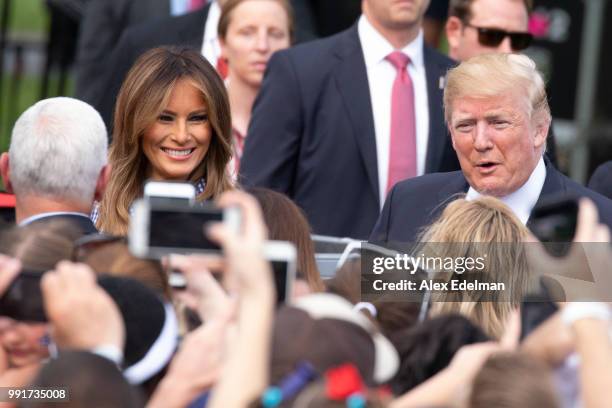 President Donald Trump and first lady Melania Trump greet guests at a picnic for military families on July 4, 2018 in Washington, DC.