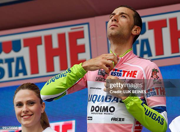 Italian Vincenzo Nibali puts on the pink jersey of leader on the podium after the fifth stage of the 93rd Giro d'Italia going from Novara to Novi...