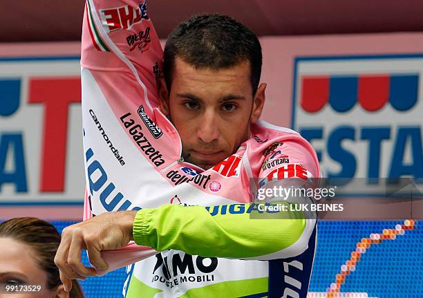 Italian Vincenzo Nibali puts on the pink jersey of leader on the podium after the fifth stage of the 93rd Giro d'Italia going from Novara to Novi...