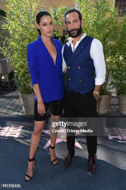 Rebecca Mir and her husband Massimo Sinato attend the Riani show during the Berlin Fashion Week Spring/Summer 2019 at ewerk on July 4, 2018 in...