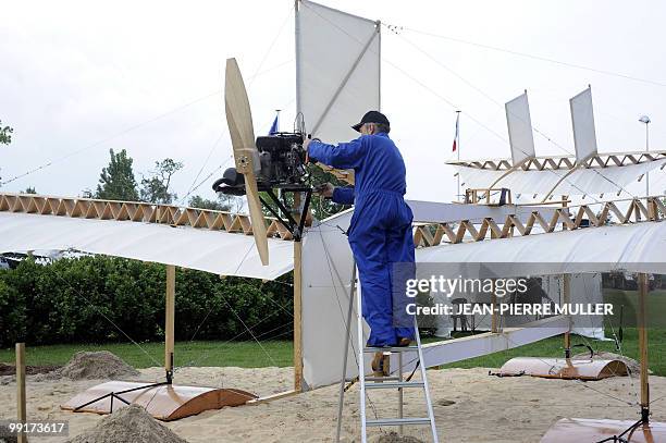 Member of "Flyersteam" old aircraft association Marc Bulin checks the engine "Le Canard" French first seaplane replica, on May 13, 2010 in Biscarosse...