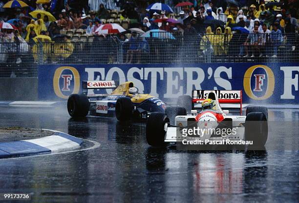 Ayrton Senna drives the Honda Marlboro McLaren McLaren MP4-6 ahead of Nigel Mansell in the Canon Williams Renault Williams FW14 in the rain during...