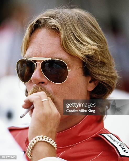 Keke Rosberg, driver of the Marlboro McLaren International McLaren TAG MP4 2C smoking a cigarette before the Brazilian Grand Prix on 20 March 1986 at...