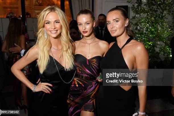 Kristina Romanova and Masha Markova Hanson attend amfAR Paris Dinner 2018 at The Peninsula Hotel on July 4, 2018 in Paris, France.
