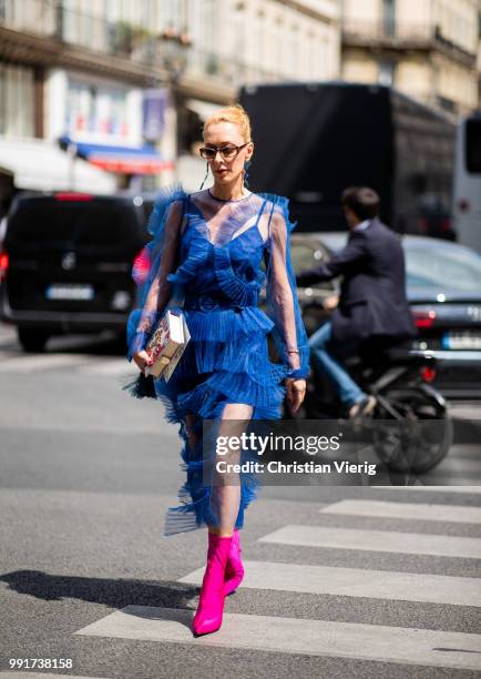 Elina Halimi wearing blue ruffled dress, ankle boots is seen outside Elie Saab on day four during Paris Fashion Week Haute Couture FW18 on July 4,...