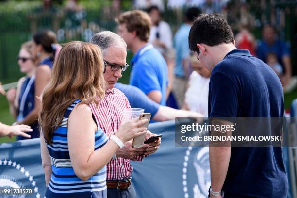 Environmental Protection Agency Administrator Scott Pruitt stands with his wife Marlyn Pruitt and son Cade Pruitt during a picnic for military...