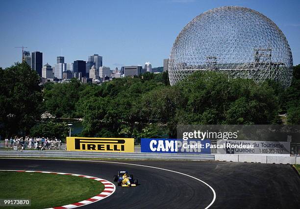 Nelson Piquet drives the Camel Benetton Ford Benetton B191 past the Biosphere from the 1967 International and Universal Exposition Expo 67 during the...