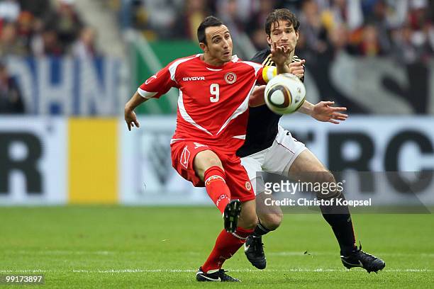 Arne Friedrich of Germany challenges Michael Mifsud of Malta during the international friendly match between Germany and Malta at Tivoli stadium on...