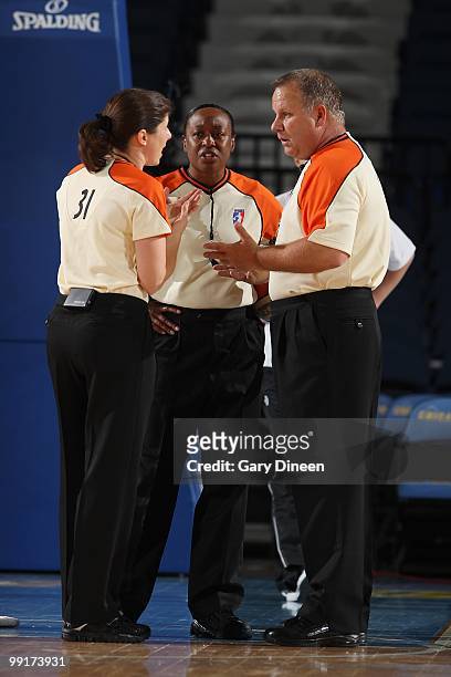 Referees Amy Bonner, Felicia Grinter and Tom Mauer huddle on the court during the WNBA preseason game between the Indiana Fever and the Chicago Sky...