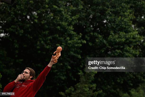 One of five anti-abortion demonstrators stands with a plastic baby doll protesting the nomination of U.S. Solicitor General Elena Kagan to the...