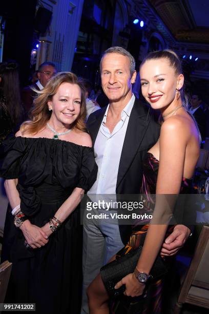 Caroline Scheufele poses for a picture with Chopard auction winner Kristina Romanova and Vladislav Doronin during amfAR Paris Dinner 2018 at The...
