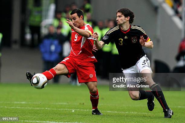 Arne Friedrich of Germany is challenged by Michael Mifsud of Malta during the international friendly match between Germany and Malta at Tivoli...