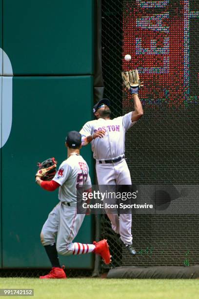 Boston Red Sox center fielder Jackie Bradley Jr. Makes a leaping catch in the third inning behind right fielder Mookie Betts during the game between...