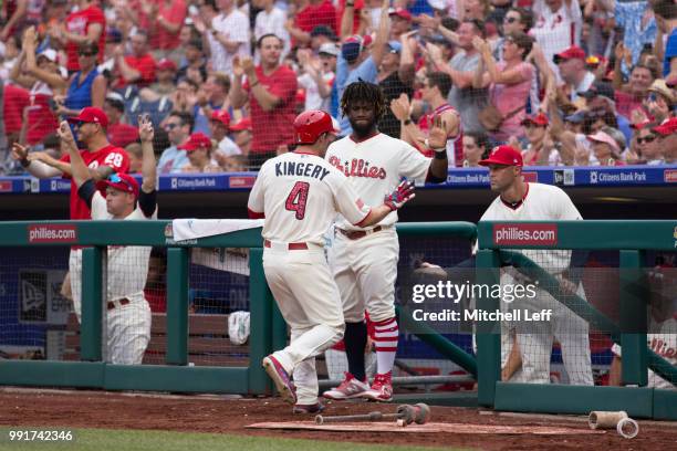 Scott Kingery of the Philadelphia Phillies celebrates with Odubel Herrera and manager Gabe Kapler after scoring a run in the bottom of the fifth...