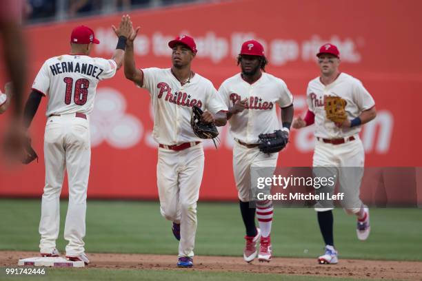 Cesar Hernandez, Nick Williams, Odubel Herrera, and Rhys Hoskins of the Philadelphia Phillies high five after the game against the Baltimore Orioles...