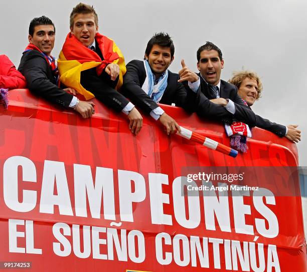 Atletico Madrid players Jose Antonio Reyes, Diego Camacho, Sergio Aguero, Raul Garcia and Diego Forlan celebrate on the top of an open bus in Madrid...