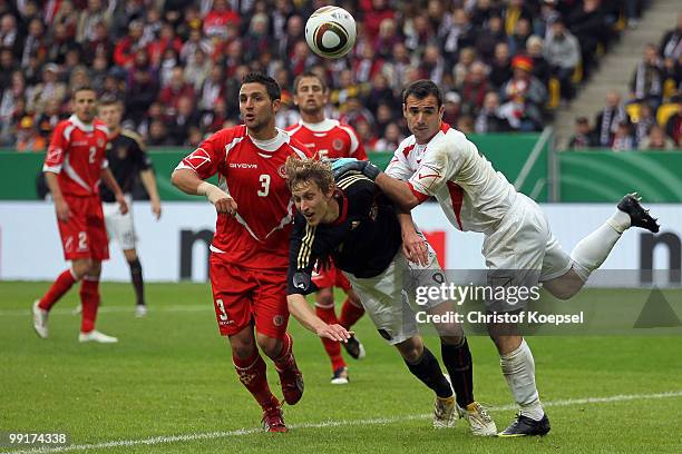 Shaun Bajada and Justin Haber of Malta challenge Stefan Kiesling of Germany during the international friendly match between Germany and Malta at...