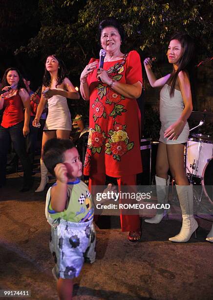 Philippine former first lady Imelda Marcos sings during a victory party at the Marcos mansion in Batac, northern province of Ilocos Norte, on May 13...