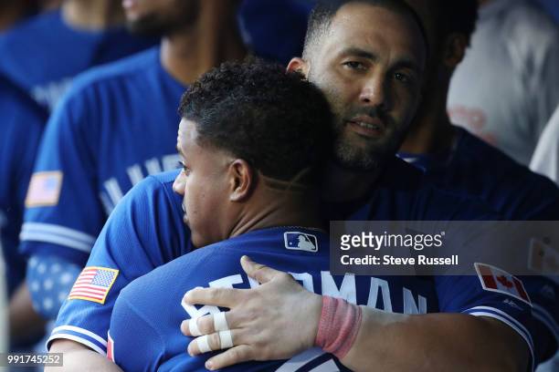 Toronto Blue Jays designated hitter Kendrys Morales earns a hug from Toronto Blue Jays starting pitcher Marcus Stroman after hitting a second inning...