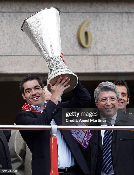 Atletico Madrid captain Antonio Lopez celebrate with the trophy next to the Enrique Cerezo, presidente of Atletico on the top of an open bus in...