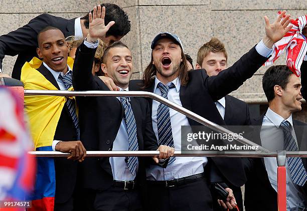 Atletico Madrid players Luis Amaranto Perea, Simao Sabrosa and Thomas Ujfalusi celebrate on the top of an open bus in Madrid the day after Atletico...