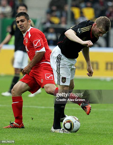 Toni Kroos of Germany is challenged by Trevor Cilia of Malta during the international friendly match between Germany and Malta at Tivoli stadium on...