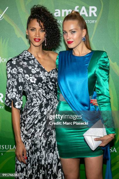 Models Noemie Lenoir and Petra Nemcova attend the amfAR Paris Dinner 2018 at The Peninsula Hotel on July 4, 2018 in Paris, France.