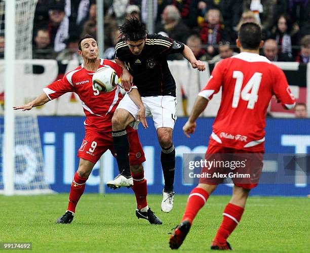 Serdar Tasci of Germany is challenged by Michael Mifsud during the international friendly match between Germany and Malta at Tivoli stadium on May...