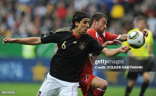 Germany's midfielder Samir Khedira and Malta's defender Andrei Agius vie for the ball during the friendly football match Germany vs Malta in the...