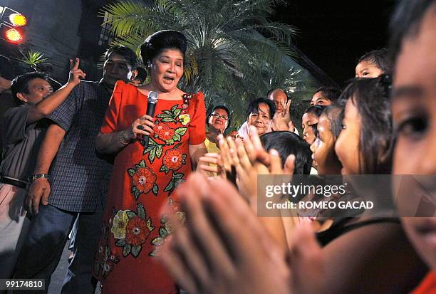 Philippine's former first lady Imelda Marcos sings to supporters during a victory party at the Marcos mansion in Batac, northern province of Ilocos...