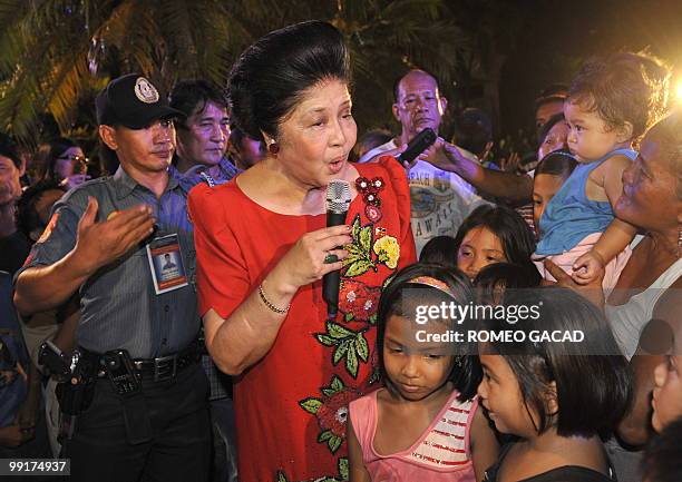 Philippine's former first lady Imelda Marcos sings to supporters during a victory party at the Marcos mansion in Batac, northern province of Ilocos...