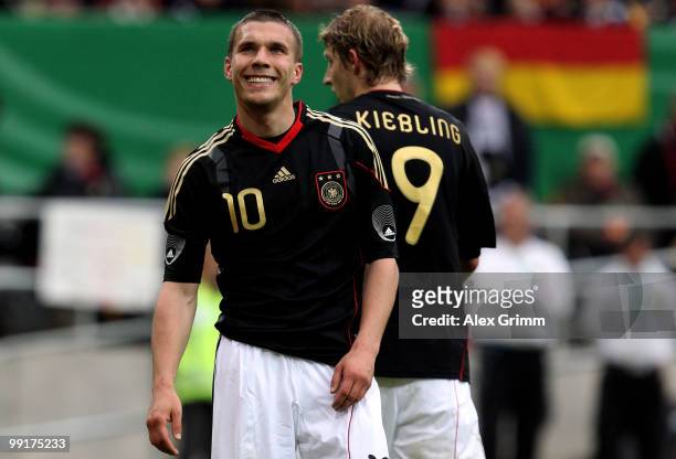 Lukas Podolski of Germany walks past with team mate Stefan Kiessling during the international friendly match between Germany and Malta at Tivoli...