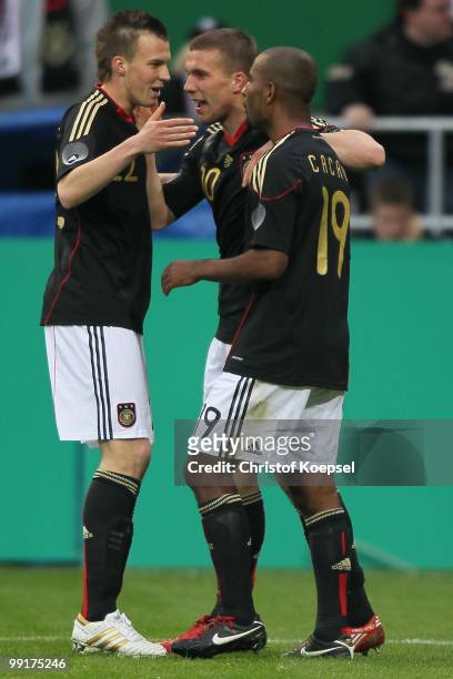 Cacau of Germany celebrates the second goal with Kevin Grosskreutz and Lukas Podolski during the international friendly match between Germany and...