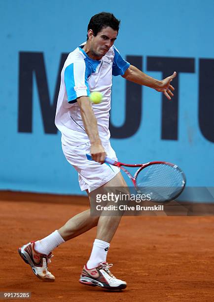 Guillermo Garcia-Lopez of Spain plays a backhand against Gael Monfils of France in their third round match during the Mutua Madrilena Madrid Open...