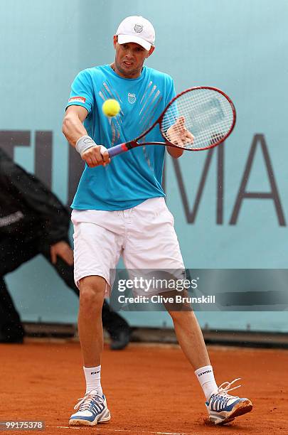 Mike Bryan of the USA in action against Benjamin Becker of Germany and Marco Chiudinelli of Switzerland in their second round doubles match during...