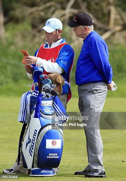 Roger Chapman of England talks with his caddie during the second round of the Handa Senior Masters presented by the Stapleford Forum played at...