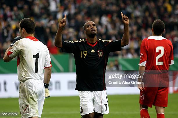 Cacau of Germany celebrates his team's second goal as goalkeeper Justin Haber and Alexander Muscat of Malta react during the international friendly...