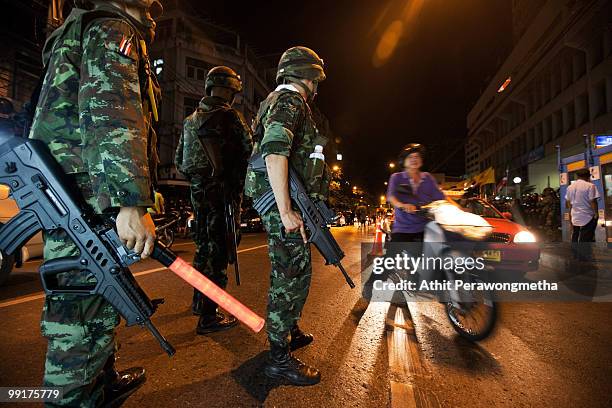 Thai soldiers check for weapons at a checkpoint in downtown Bangkok on May 13, 2010 in Bangkok, Thailand. Protesters and military forces clashed in...