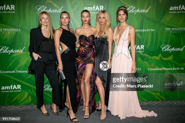 Masha Hanson , Model Kristina Romanova and Victoria Lopyreva pose with guests as they attend the amfAR Paris Dinner 2018 at The Peninsula Hotel on...