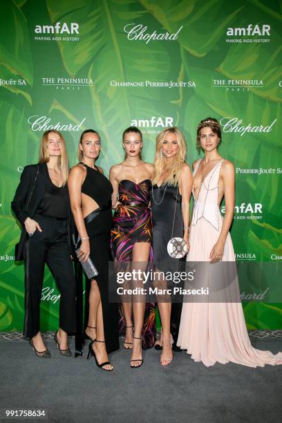 Masha Hanson , Model Kristina Romanova and Victoria Lopyreva pose with guests as they attend the amfAR Paris Dinner 2018 at The Peninsula Hotel on...