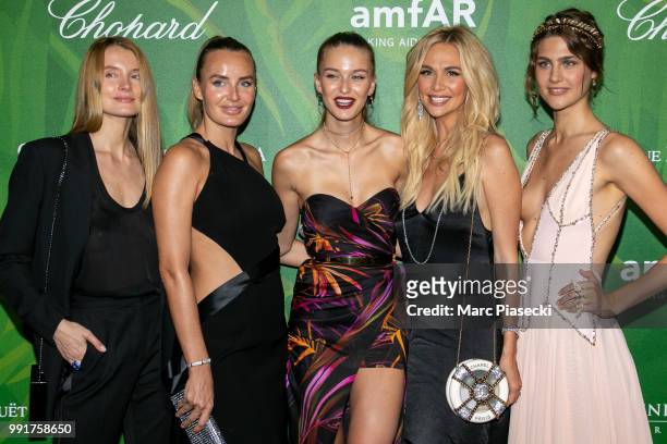 Masha Hanson , Model Kristina Romanova and Victoria Lopyreva pose with guests as they attend the amfAR Paris Dinner 2018 at The Peninsula Hotel on...
