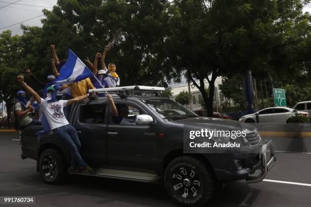 Masked protesters are seen on a truck as they take part in a protest against Nicaraguan President Daniel Ortega's government in Managua, Nicaragua on...